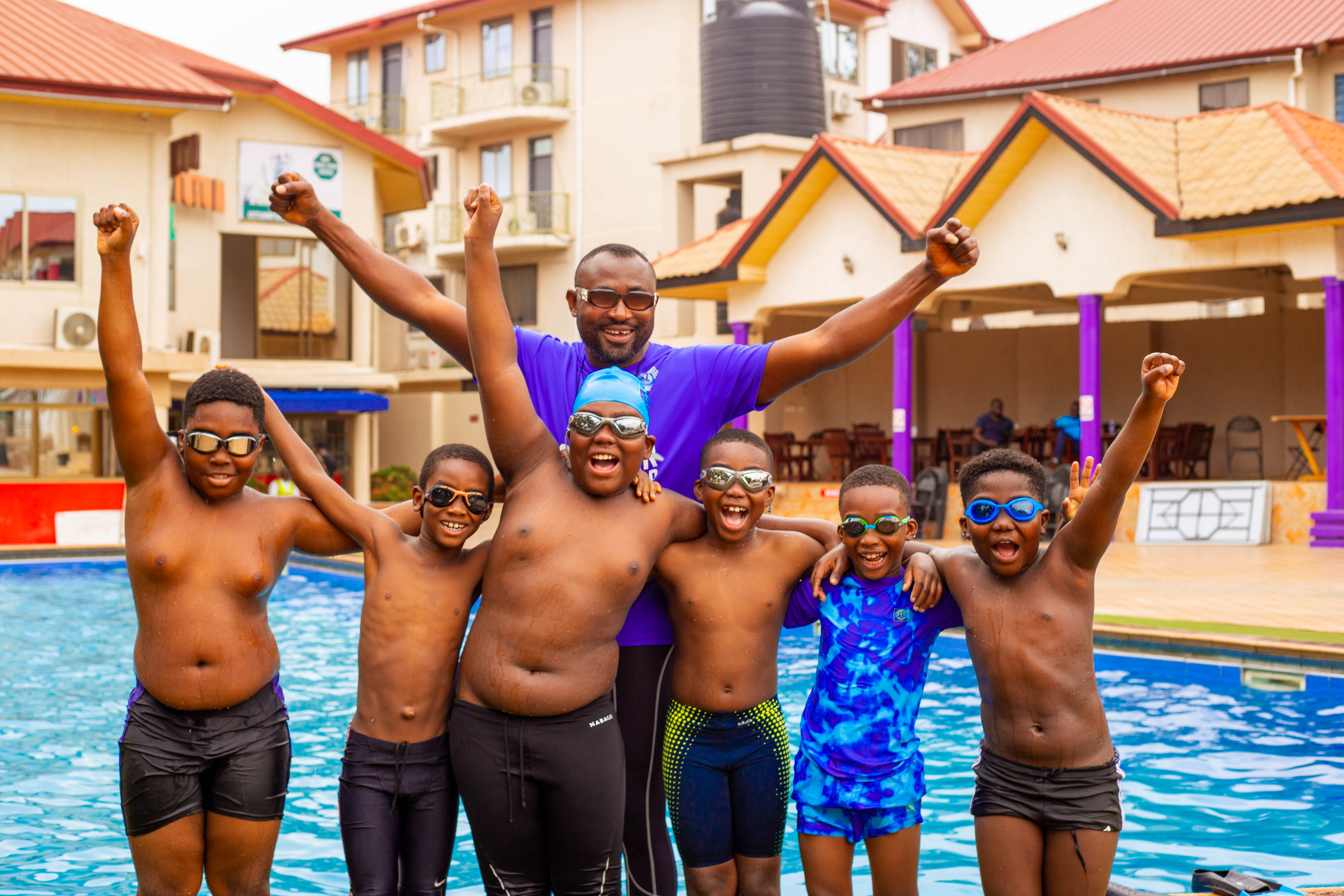 Swim Africa Ghana swimmers and coaches celebrating poolside