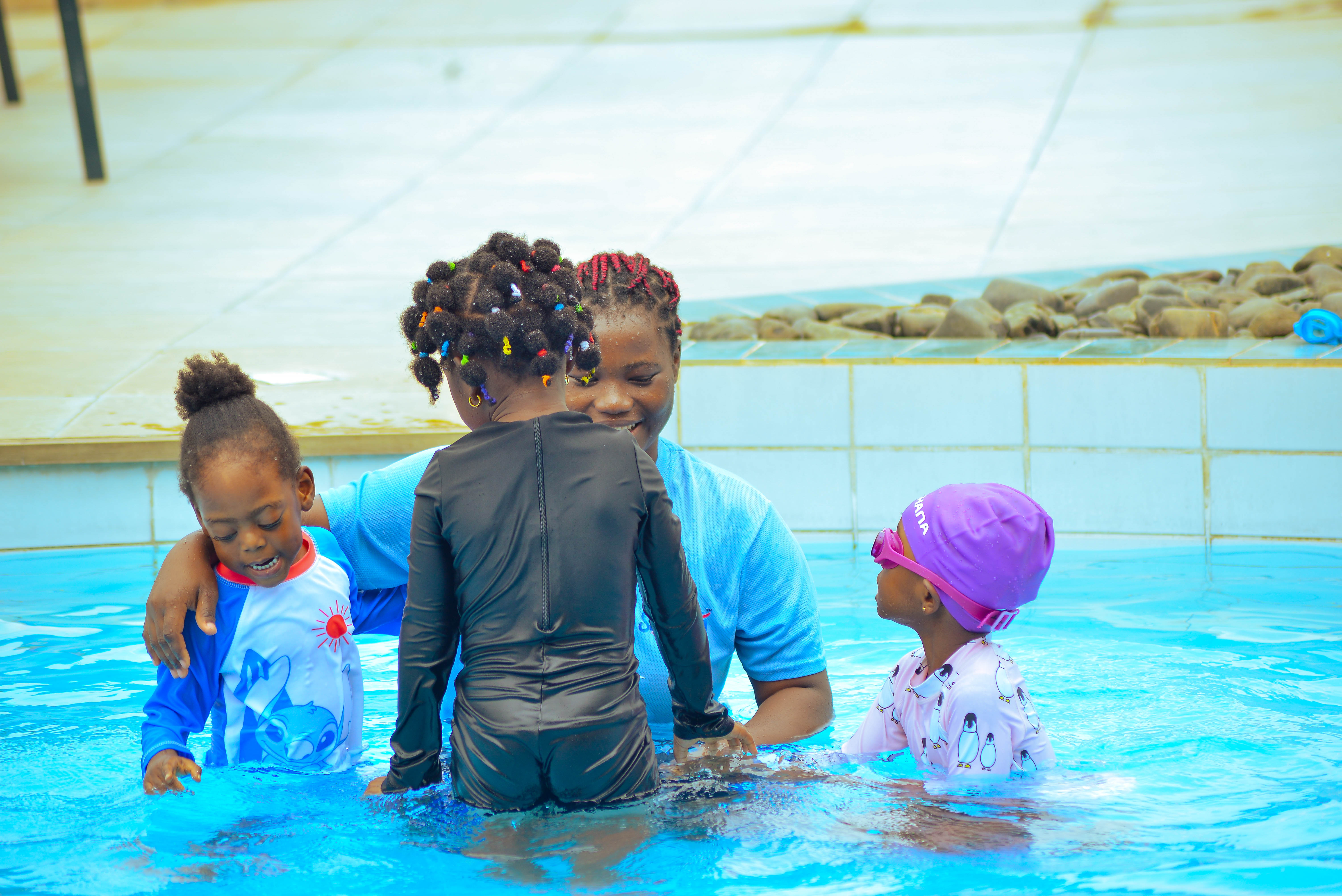 Children in Swim School caps at a Gaia lesson