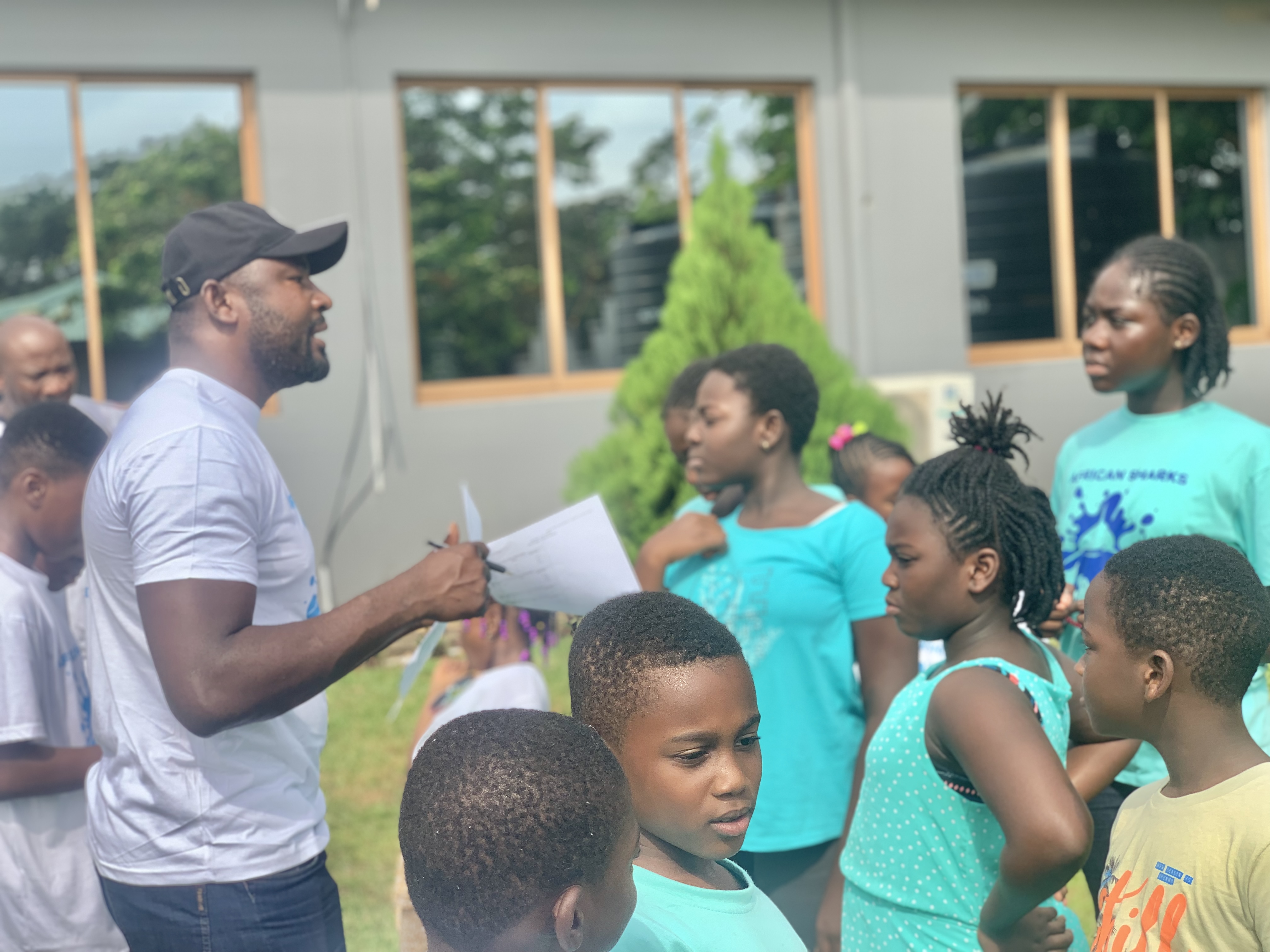 A coach instructing a group on deck