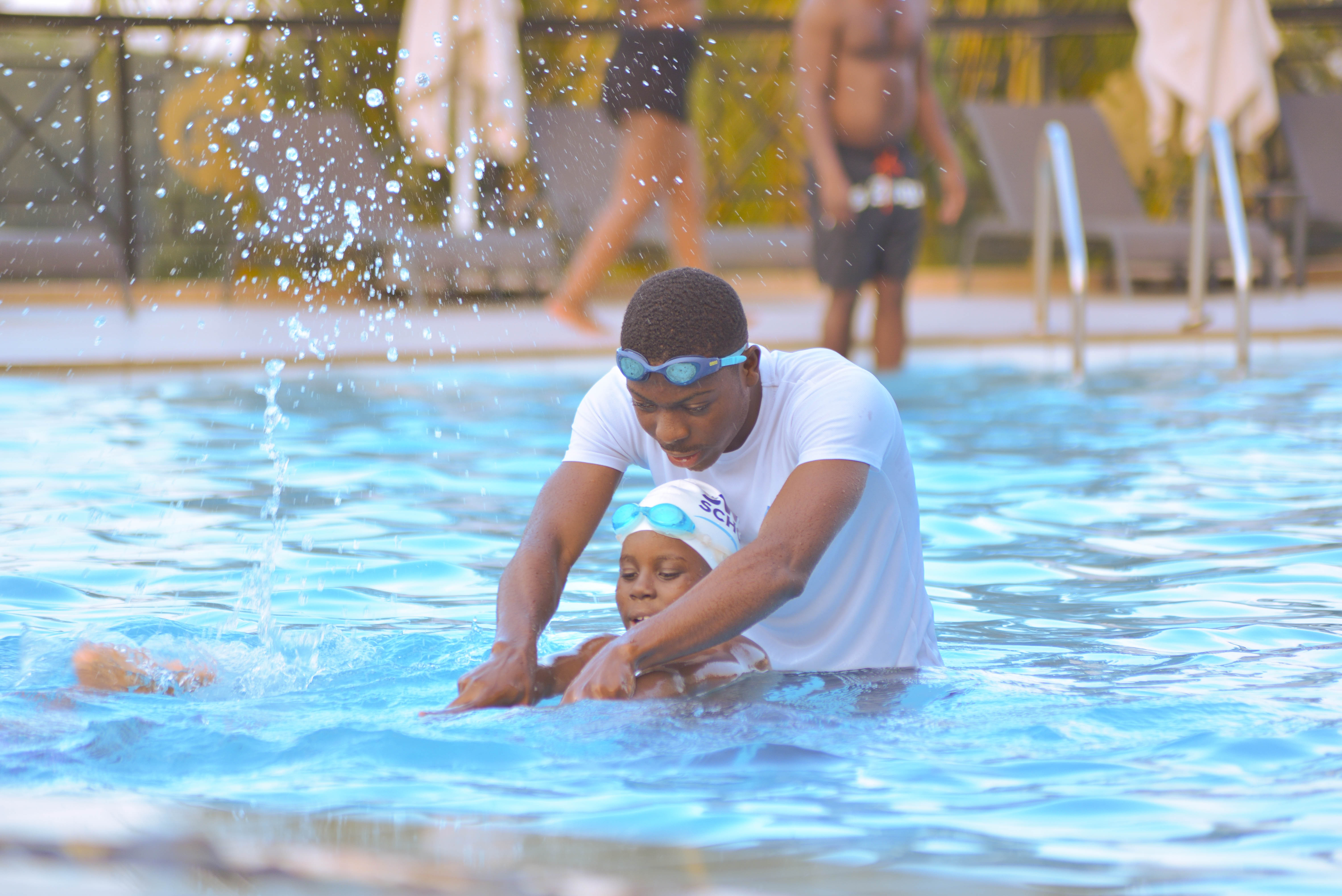 A coach teaching a small group of children in the pool