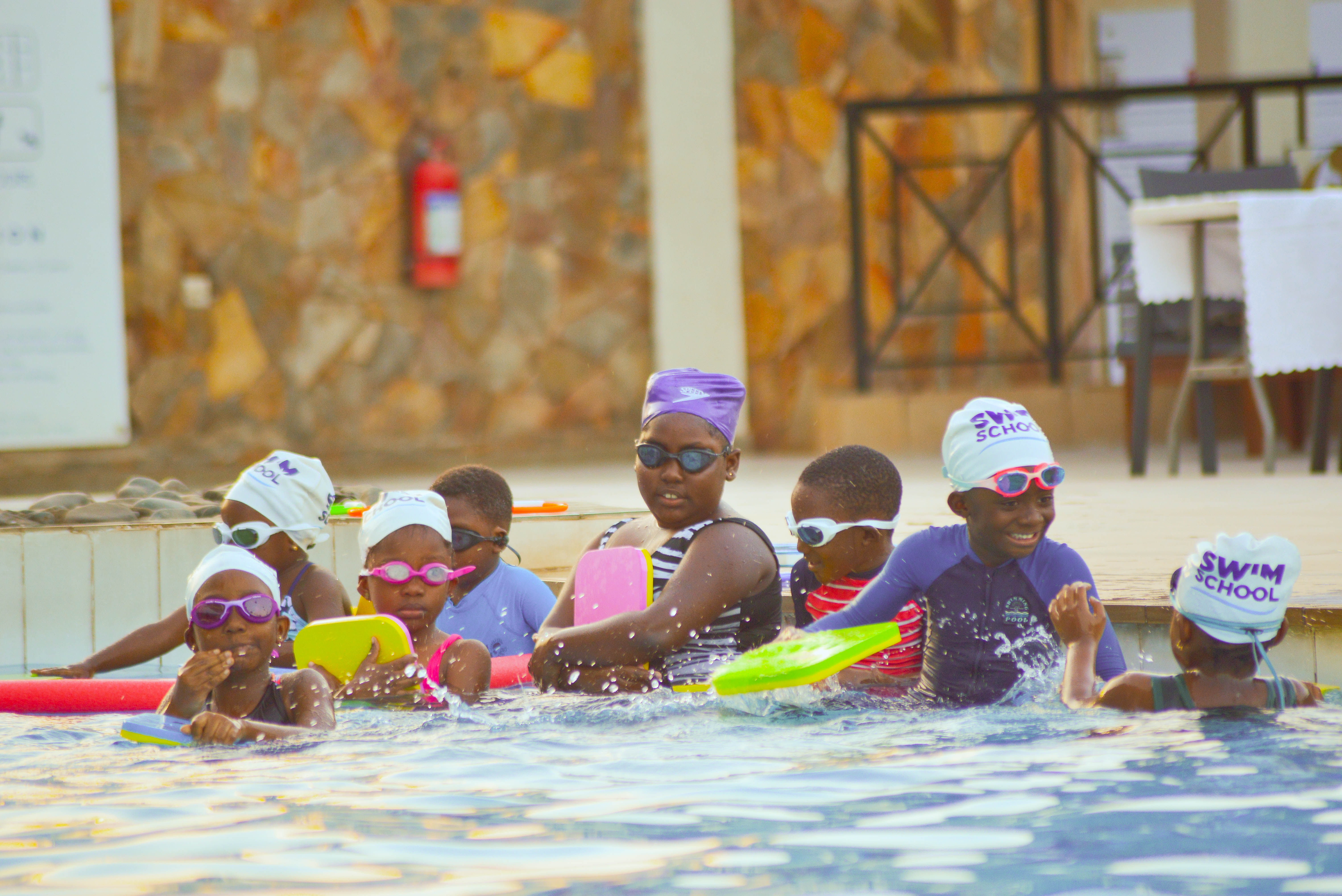 A group swimming lesson at the poolside