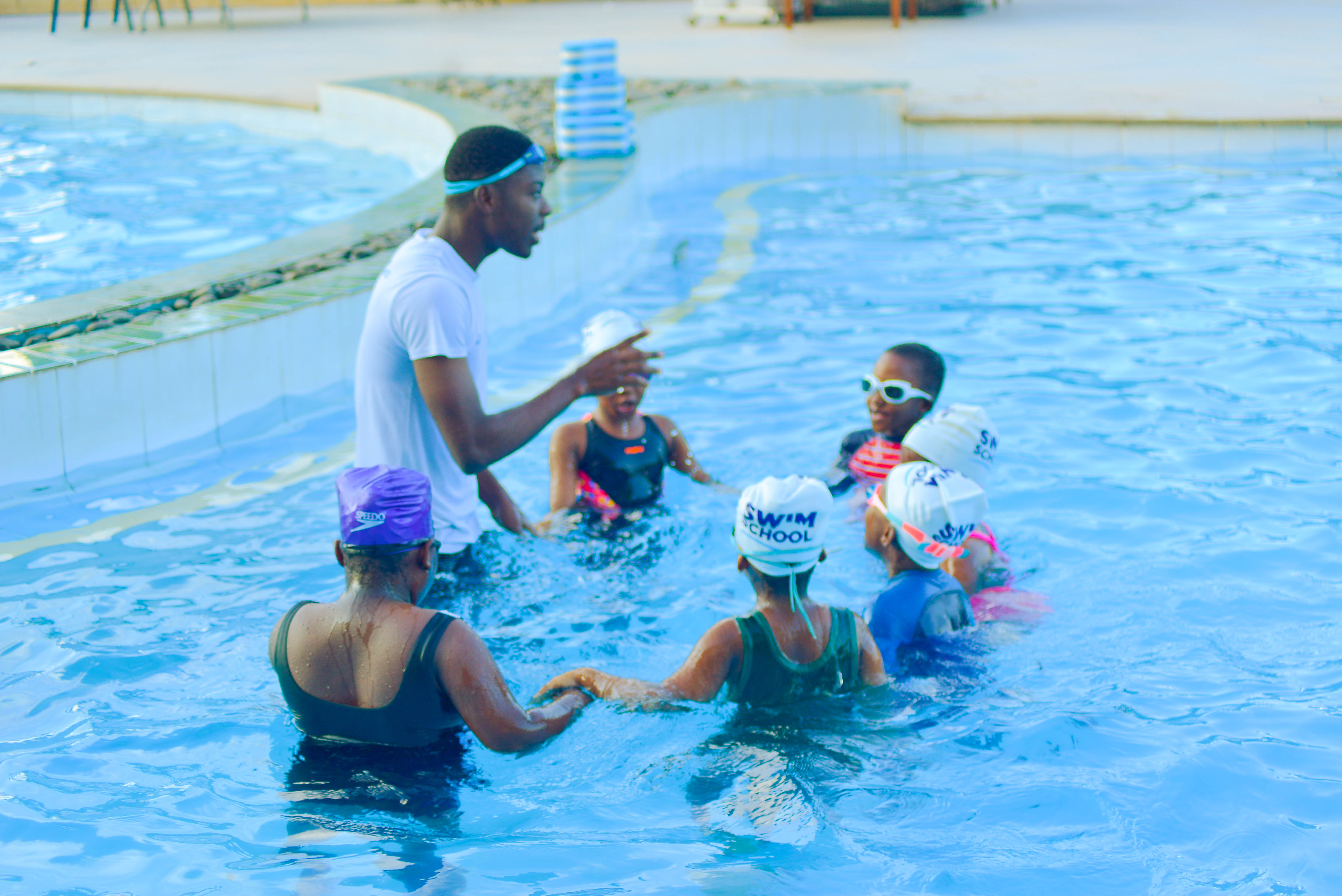 A Swim Africa Ghana coach teaching children in the pool